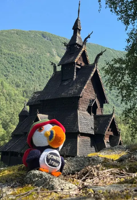 Fluffy in front of Borgund Stave Church in Norway